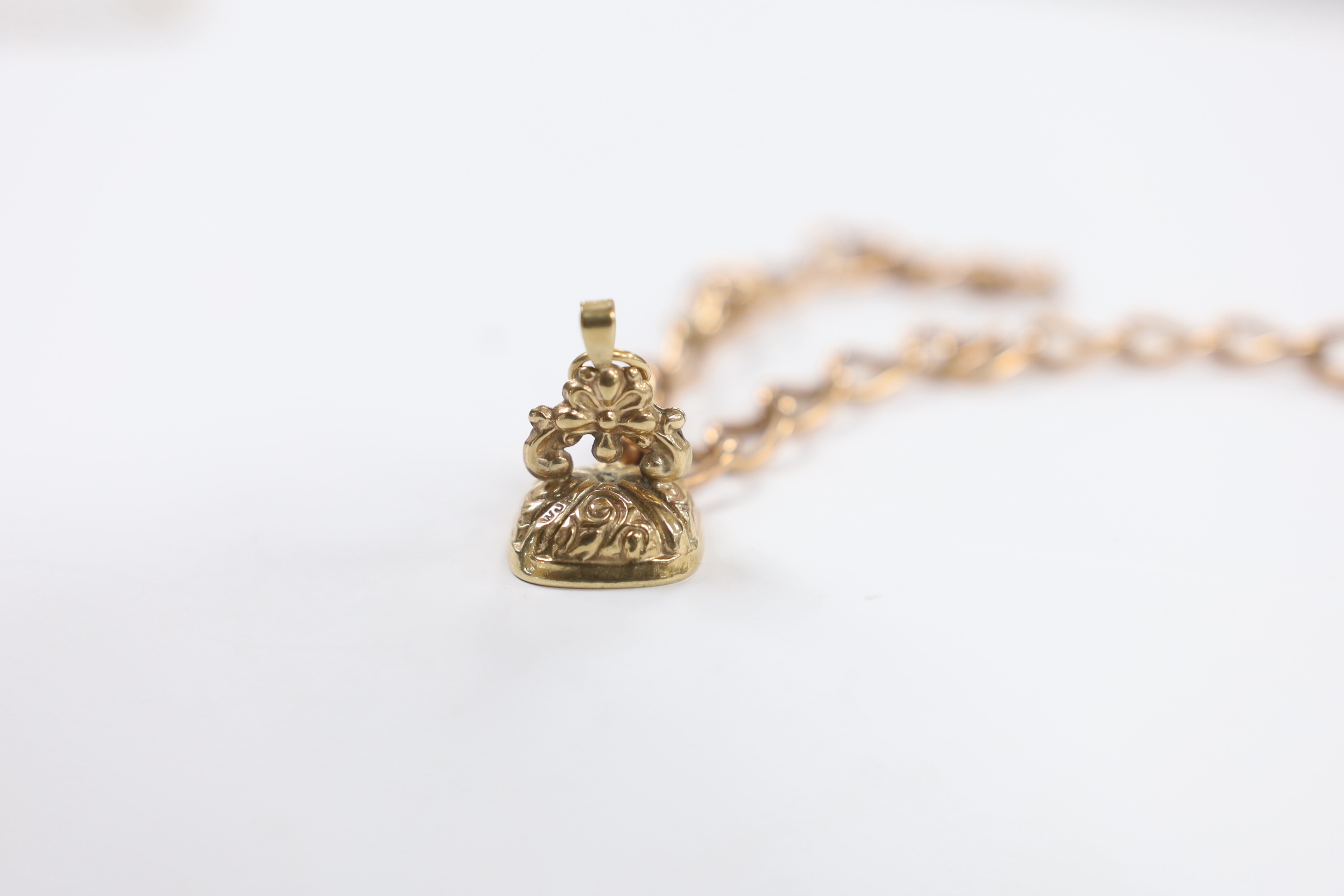 A yellow metal overlaid fob seal on a damaged 9ct gold bracelet, together with a yellow metal masonic ball on a yellow metal chain.